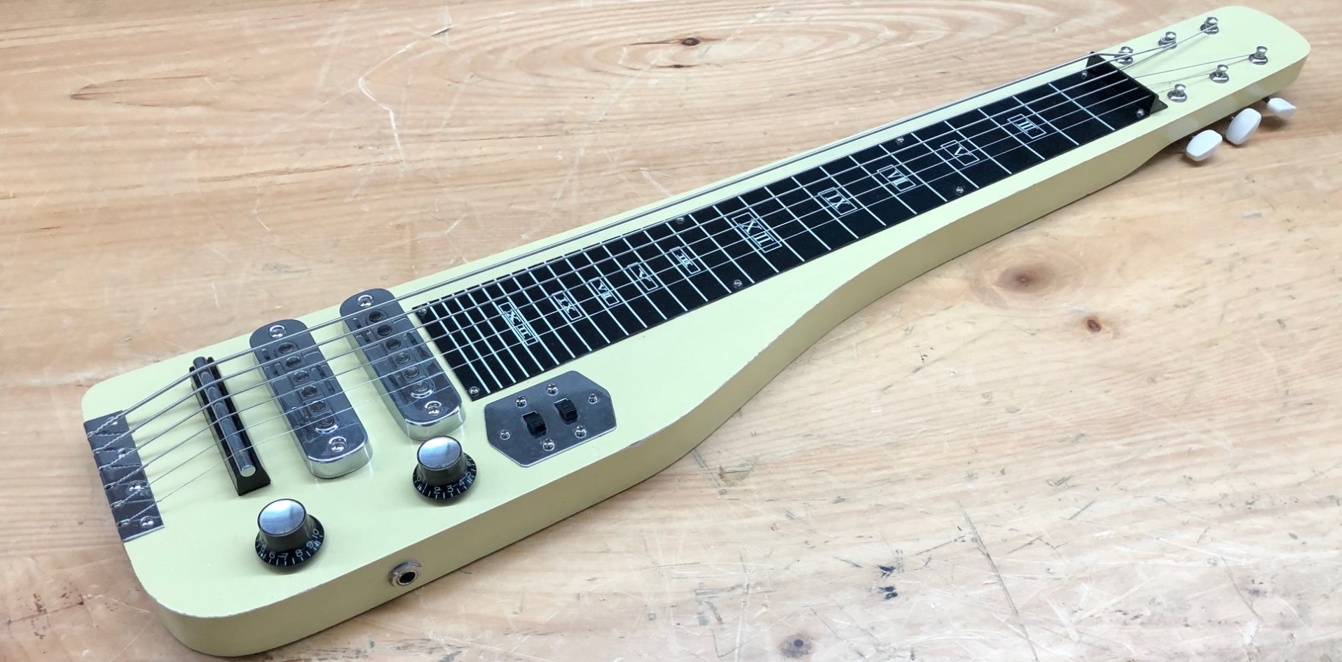 A lap steel guitar. Looks a bit like someone hacked off the lower portion of an electric guitar.