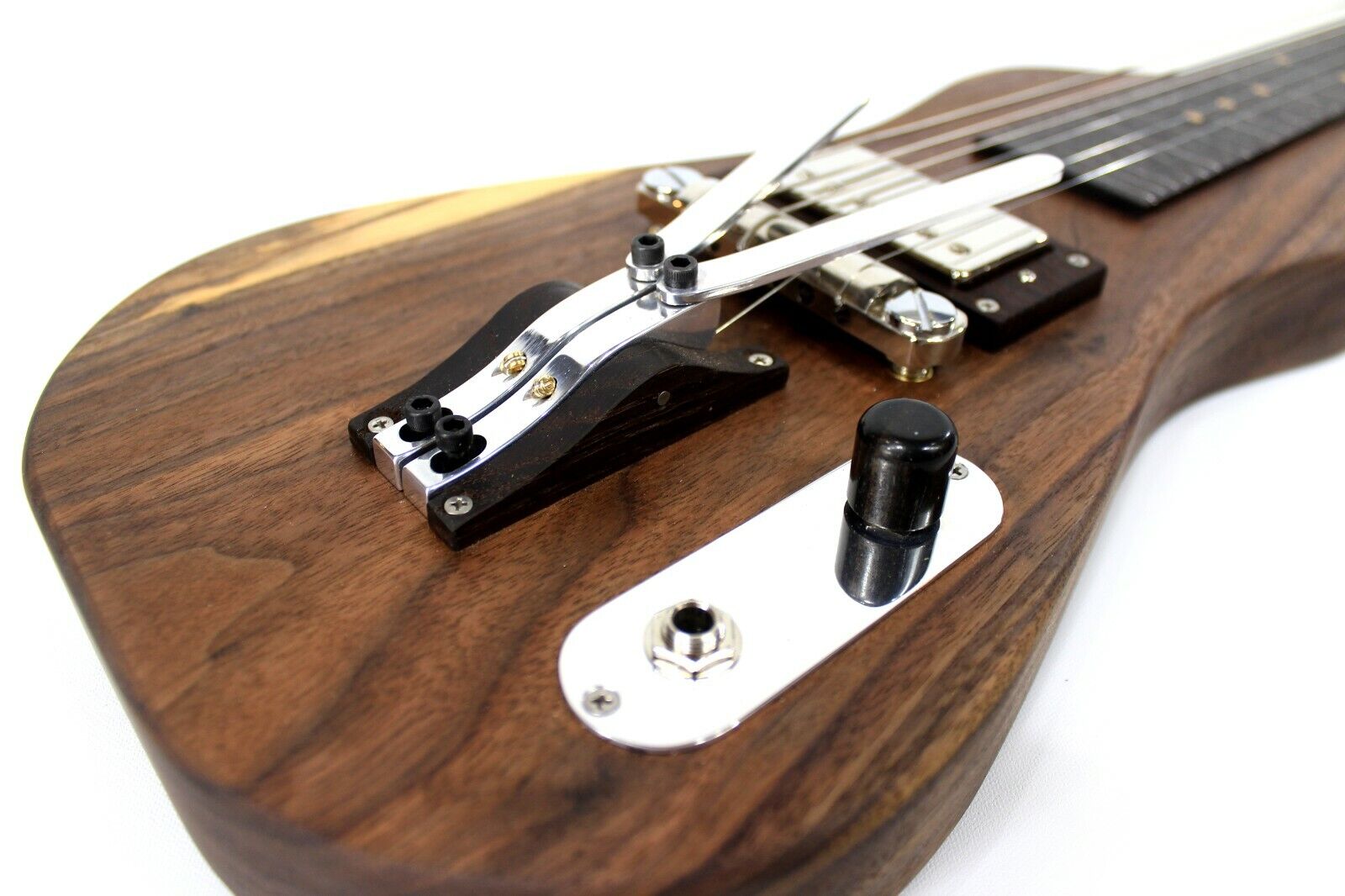 A close-up on a lap steel guitar's palm levers.